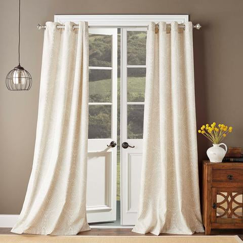 ivory printed curtain on window in room
